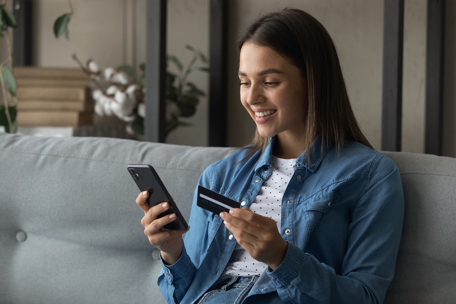 A women accessing online banking on her couch